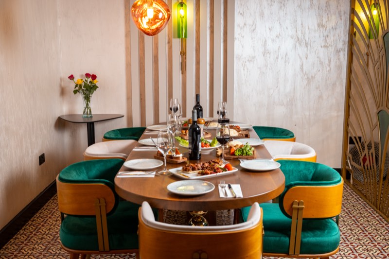 An elegantly set table under warm lamplight